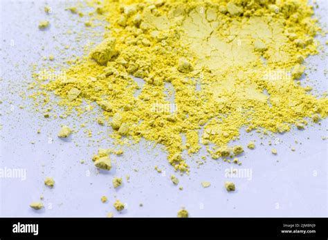 Yellow color background of chalk powder. Yellow color dust particles splattered on white ...