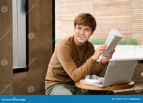 Asian Man Reading Book in Coffee Shop Stock Photo - Image of studying ...