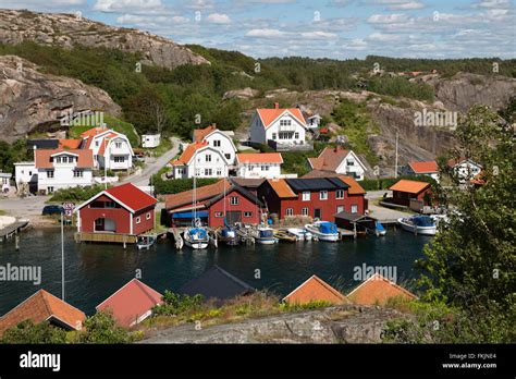 Traditional falu red fishermen's houses and summer houses along coastline, Hamburgsund, Bohuslän ...