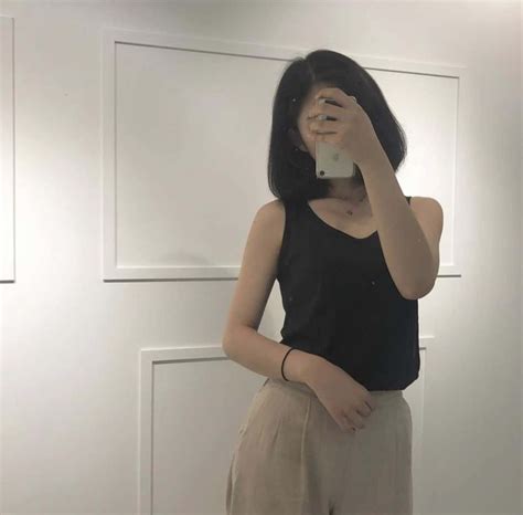 Download A Woman Taking A Selfie In A Mirror | Wallpapers.com