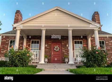 Front facade of a modern house with pillars Stock Photo - Alamy