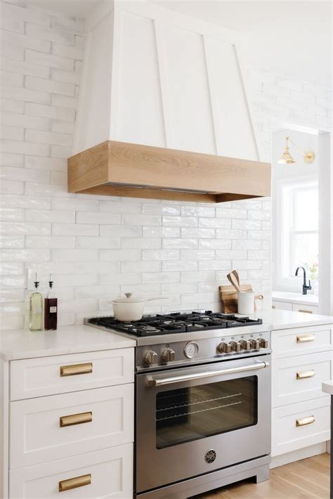 Board and Batten Hood with White Oak Detail The custom range hood anchors the kitchen and the ...