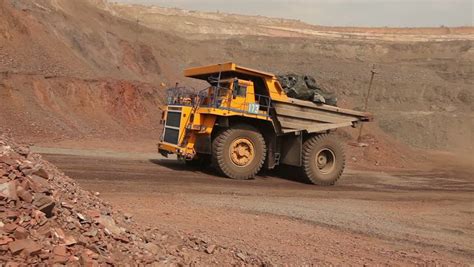 Mining Trucks In Giant Open Pit Mine, Heavy Mining Truck Loaded With Iron Ore On The Opencast ...