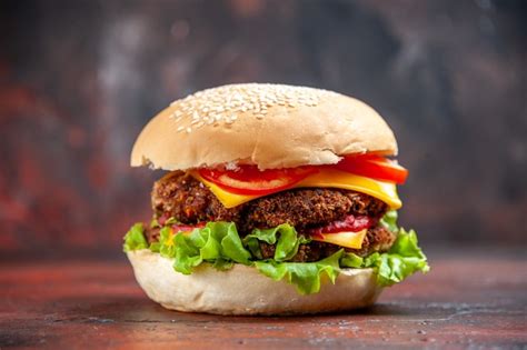 Free Photo | Front view tasty meat burger with cheese and salad on dark background