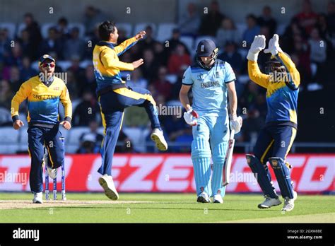 England’s Chris Woakes is caught behind by Sri Lanka's Kusal Perera off ...