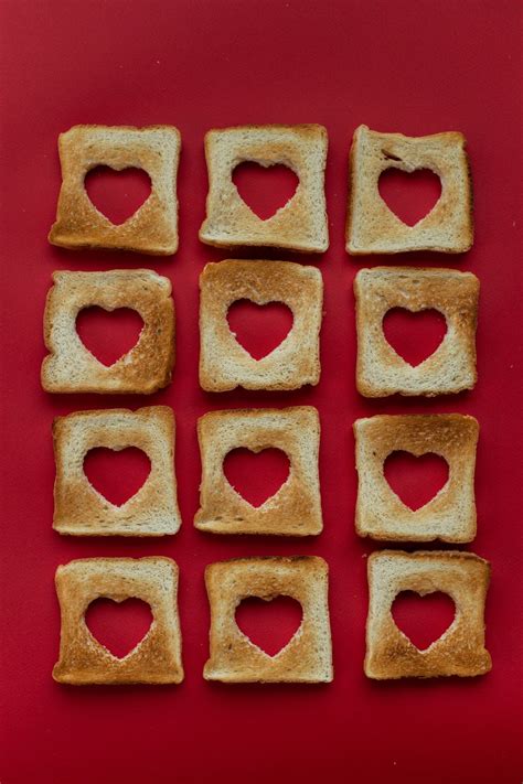 Slices of toasted bread with cut out hearts · Free Stock Photo