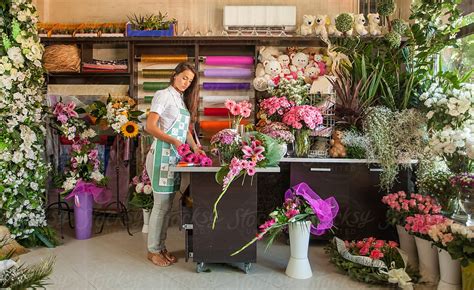 "Florist Working In Her Flower Shop." by Stocksy Contributor "Mosuno ...