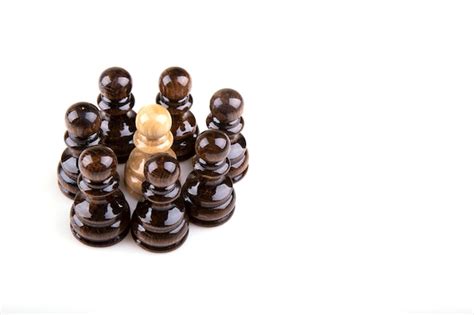 Premium Photo | Single pawn against all black pawns isolated on white background - concept of an ...