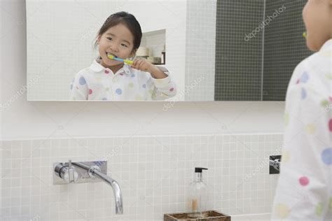 Japanese Girl Brushing Teeth — Stock Photo © londondeposit #33833395