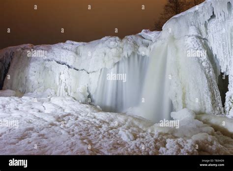 Frozen waterfall at night. Light painting illumination Stock Photo - Alamy