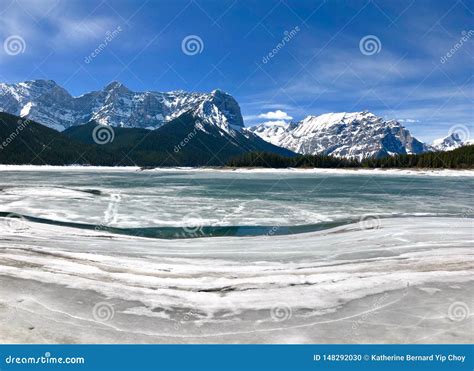 The Canadian Rocky Mountains in Winter with a Frozen Lake Stock Photo ...