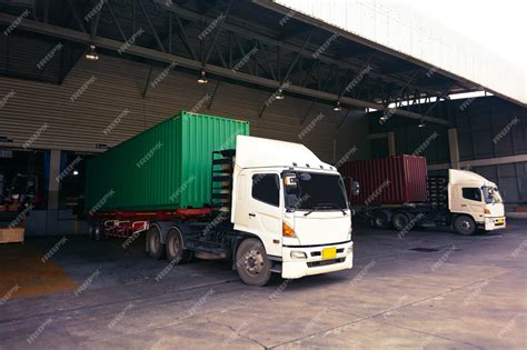 Premium Photo | Truck industrial with green and red container yard with forklift working in ...