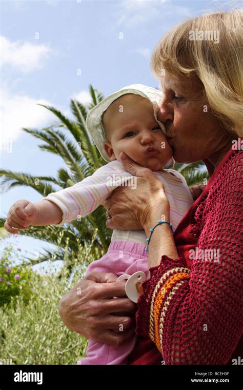 Old lady holding a baby in her arms, Conil de la Frontera, Spain Stock Photo - Alamy