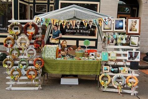 A super unique booth setup. Love the sideways picket fences that display wreaths....Although we ...