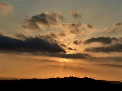 Crepuscular rays come through dense clouds at sunset before storm ...