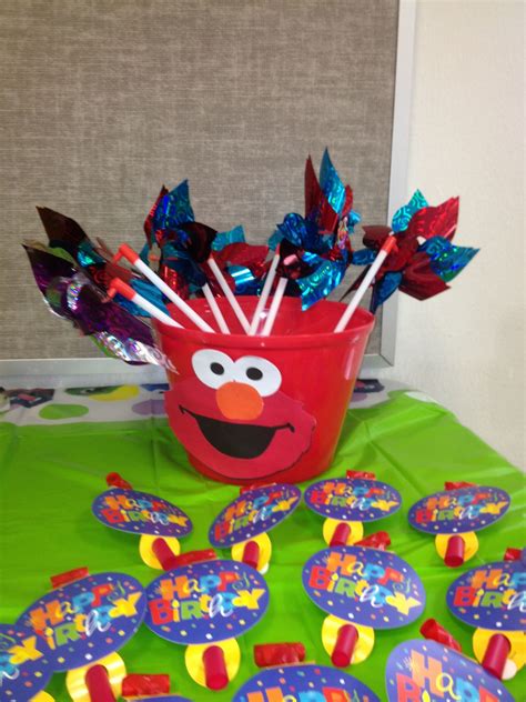 Elmo party favors- pinwheels, blowers and a $1 bucket from Dollar General. Face made using the ...