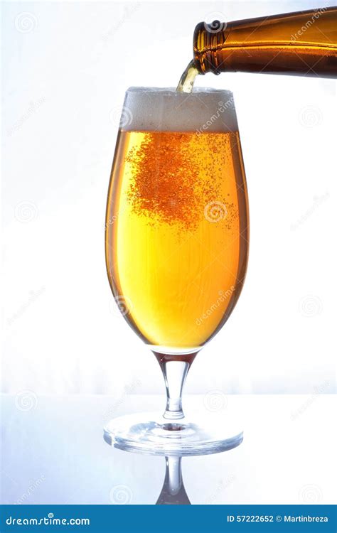 Pouring beer from bottle stock photo. Image of liquid - 57222652