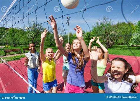 Sportive Teenagers are Playing Volleyball Together Stock Image - Image of arms, activity: 65983449