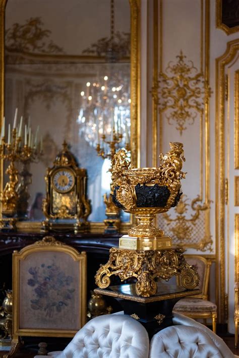 an ornately decorated room with gold and white furniture