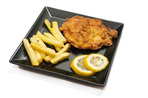 Vienna Steaks served with french fries and lemons - Creative Commons Bilder