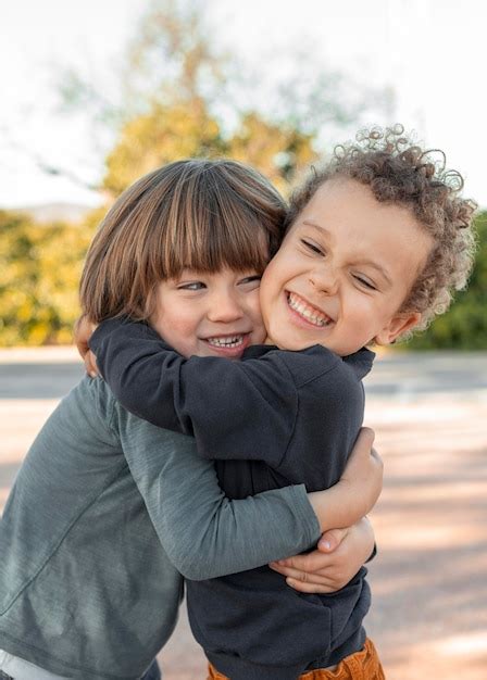 Free Photo | Little boys outdoors hugging