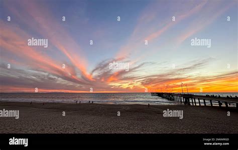 Colorful sunset lights up the beach, pier and ocean in Los Angeles Stock Photo - Alamy