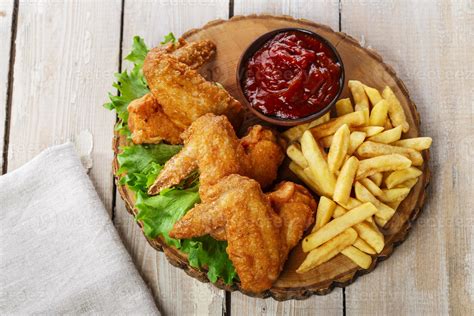 Fried chicken wings with sauce and French fries 722527 Stock Photo at ...