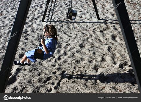 Young School Girl Age Wearing School Uniform Swinging Alone Swing — Stock Photo © lucidwaters ...