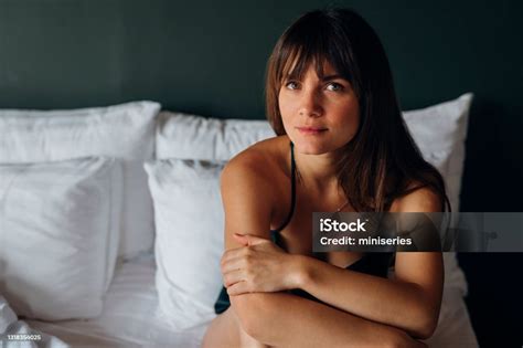 Portrait Of A Young Beautiful Woman Sitting In King Size Bed On Weekend ...