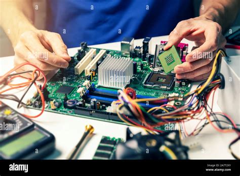 installing computer hardware - technician install CPU on motherboard Stock Photo - Alamy