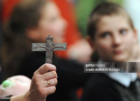 A faithful of the Neocatechumenal Way holds a Holy cross during a ...