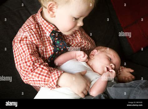 A little boy holding a baby Stock Photo - Alamy