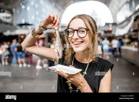 Woman with dutch herring Stock Photo - Alamy