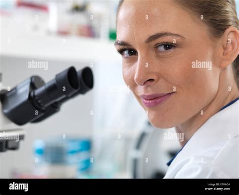 Portrait of female scientist by a microscope Stock Photo - Alamy