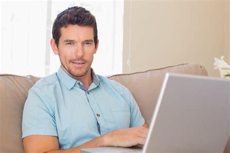 Premium Photo | Portrait of a smiling man using laptop