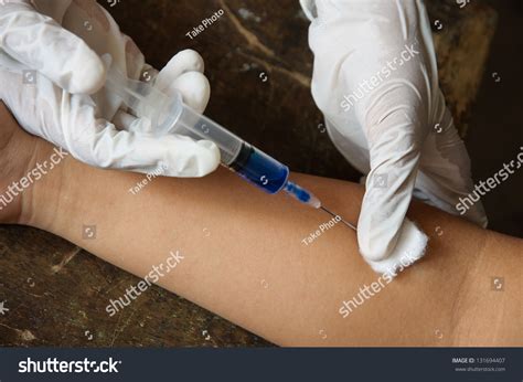 Doctor Giving An Injection To Female Student Arm. Stock Photo 131694407 : Shutterstock