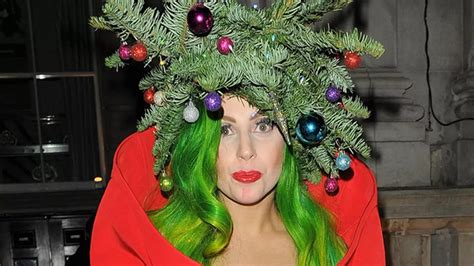 Lady Gaga wears a Christmas tree with a star and baubles on her head as ...