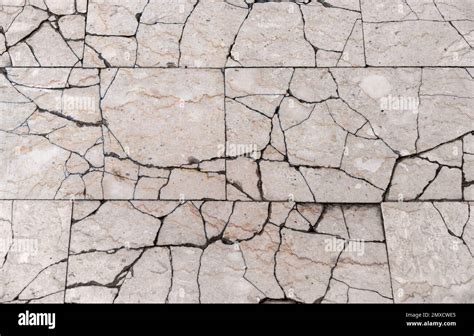 Full frame detail showing lots of broken floor tiles seen from above ...