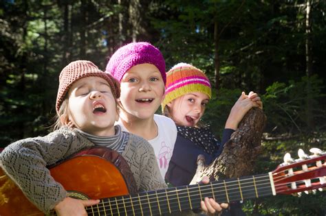 Group of children singing and playing guitar together in the for