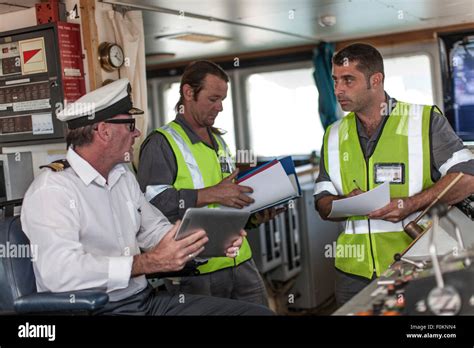 Ship crew and captain on bridge Stock Photo - Alamy