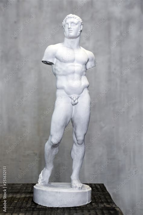 Statue of naked young man, armless, Roman and Greek art. Small plaster ...