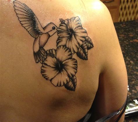 Hummingbird tattoo with hibiscus flowers