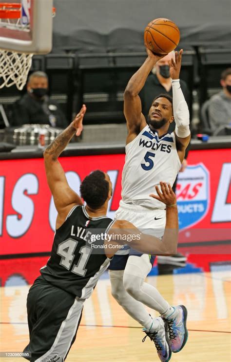 Malik Beasley of the Minnesota Timberwolves shoots over Trey Lyles of ...