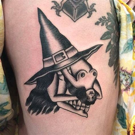 Traditional witch tattoo on the thigh.