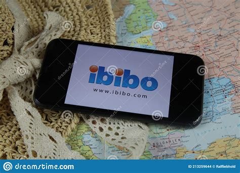 Closeup of Mobile Phone Screen Wit Logo Lettering of Online Booking Travel Agency Ibibo with Sun ...