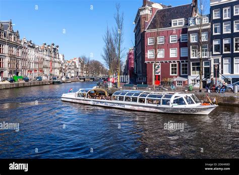 Hop on Hop off Canal Cruises in Herengracht, Amsterdam, Netherlands Stock Photo - Alamy