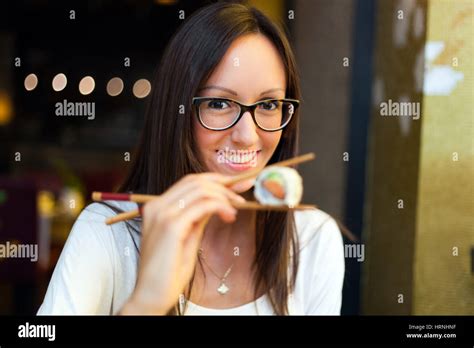 Woman eating sushi Stock Photo - Alamy