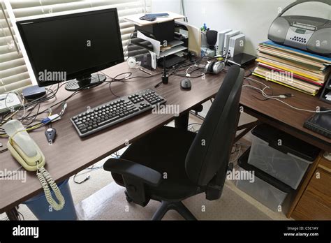 Busy, cluttered, home office table desk Stock Photo - Alamy