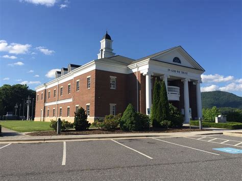 an old brick building with a steeple on the top and columns at the front