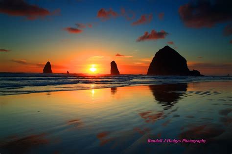 Sunset Haystack Rock and The Needles from Cannon Beach Along The | Sunset, Beach tattoo, Cannon ...